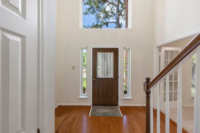 Two story foyer with large window floods the entry