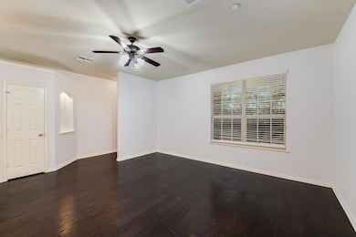Spare room featuring ceiling fan, dark wood-type 