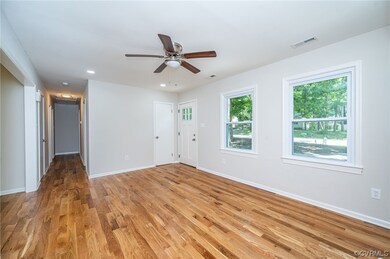 Living room with view of entry to kitchen, hallway
