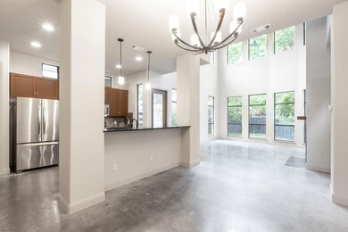Unfurnished living room with concrete flooring, a