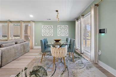 Dining room featuring visible vents, baseboards, a