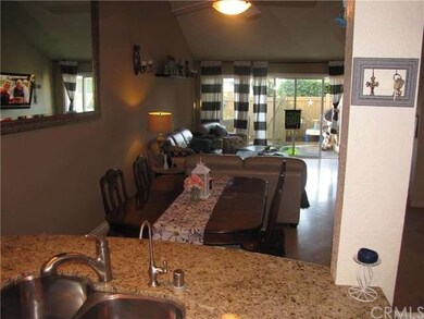 View from sink to living room and back patio