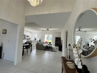Living room with marble finish floor, ceiling fan 