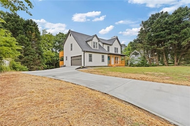 View of property exterior with covered porch, roof