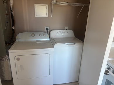 Washroom featuring separate washer and dryer and heating unit