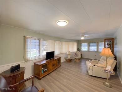 Living room featuring ceiling fan, hardwood / wood