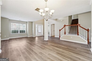 Unfurnished living room featuring stairs, a notabl