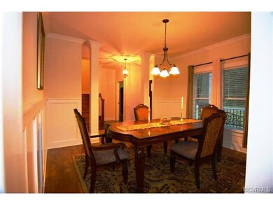 Formal dining room with hardwood floors, wainscoti