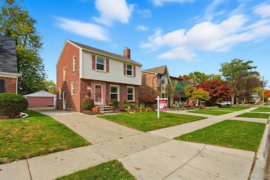 Colonial house with a chimney, brick siding, an outdoor structure, a garage, and a front lawn