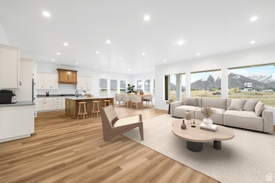 Living area with light wood-type flooring, a mountain view, and recessed lighting