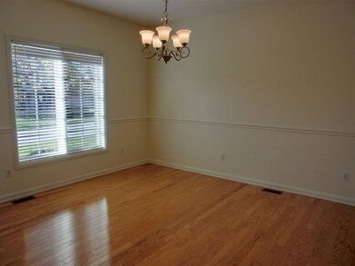 Dining room with wood floors & a new chandelier