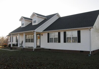 Covered front porch to greet faces the east for shade in the afternoons. 