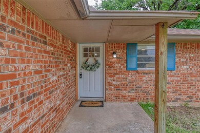 View of exterior entry with brick siding