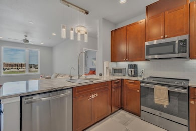 Kitchen with decorative backsplash, appliances wit