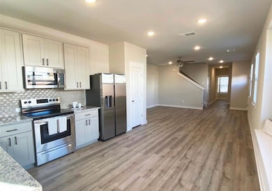 Kitchen featuring stainless steel appliances, bac