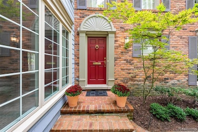 View of exterior entry with brick siding