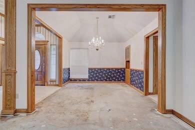 Dining area featuring a chandelier and vaulted cei