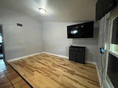 Unfurnished living room featuring baseboards and 