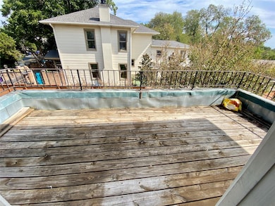View of swimming pool with a wooden deck