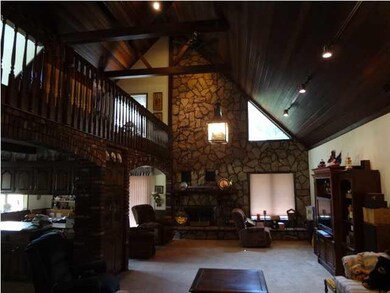 Vaulted Ceilings & Loft highlight the brick firepl