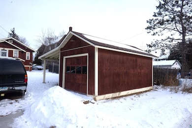 Snow covered structure featuring a garage