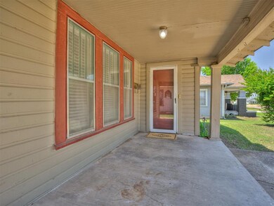 Entrance to property featuring a patio and a yard.