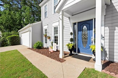 Property entrance featuring driveway and a garage