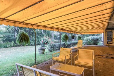 Delightful back patio overlooks the tranquil yard.