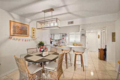 Dining space with light tile patterned floors