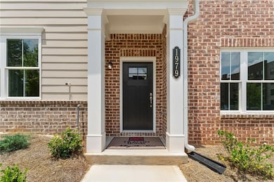 View of exterior entry with brick siding