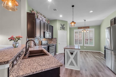 The kitchen has farmhouse touches and granite coun