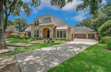 Expansive driveway with automatic gate and 3-car g