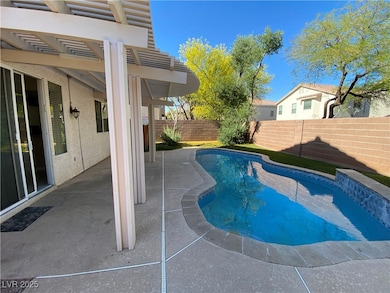 View of swimming pool with a covered patio.
