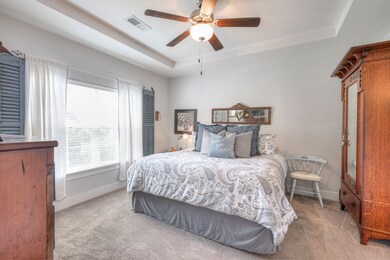 The primary bedroom is conveniently located toward the back of the townhouse on the main level and has a view of the tree-lined backyard.