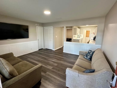 Living room featuring dark wood-style floors and b