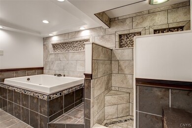 Jetted tub and jus around the corner there is a hu