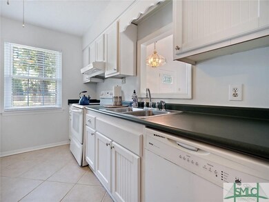 All white kitchen with while cabinets and ceramic 