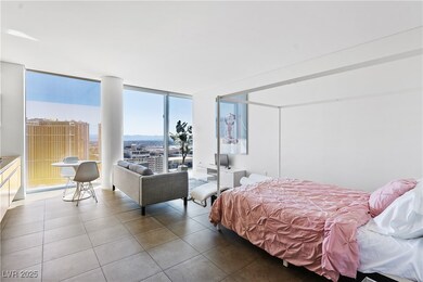 Bedroom with tile patterned floors and floor to ce