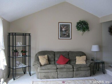 Great Room. Spacious great room with vaulted ceiling, painted walls, and neutral wall to wall carpet.  Lots of light from the new sliding door.
