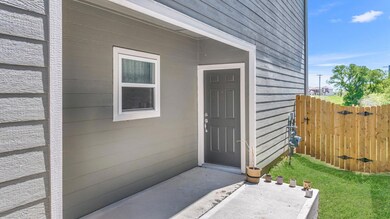 View of exterior entry featuring fence
