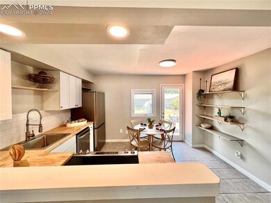 Kitchen with tasteful backsplash, wooden counters,