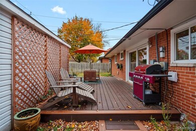Wooden terrace featuring a grill