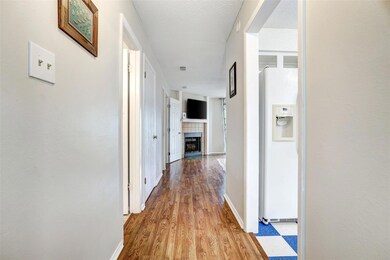 Corridor with baseboards and wood finished floors