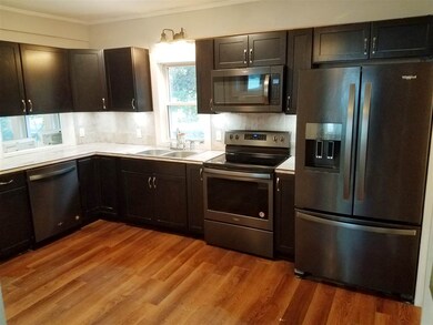 Fully updated kitchen with black stainless appliances.