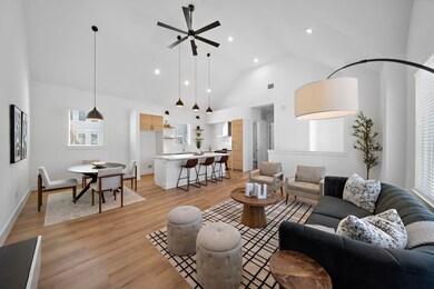 Living/kitchen/dining areas enveloped together cre