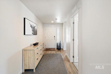 Corridor featuring light wood finished floors and baseboards