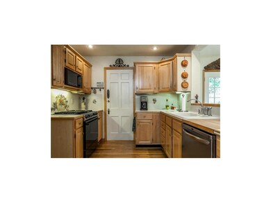 Updated Kitchen with Maple Cabinetry Overlooks Fam