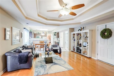large family room with ceiling fan, ornamental cro