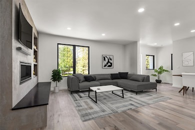 Living room featuring  light wood-flooring, and a fireplace
