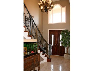 Two story Entry with marble flooring and wrought i